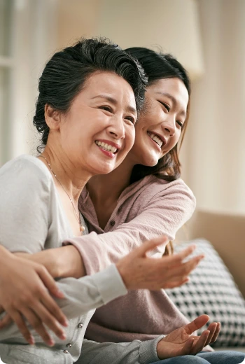a woman hugging another woman