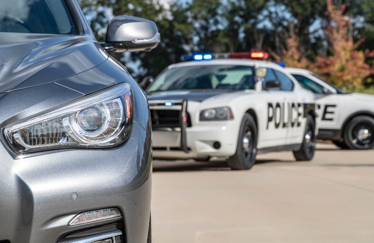 Two police cars stop a sedan