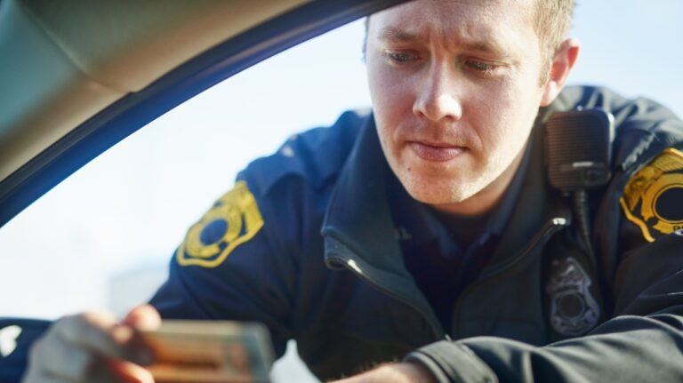police officer checks driver's license