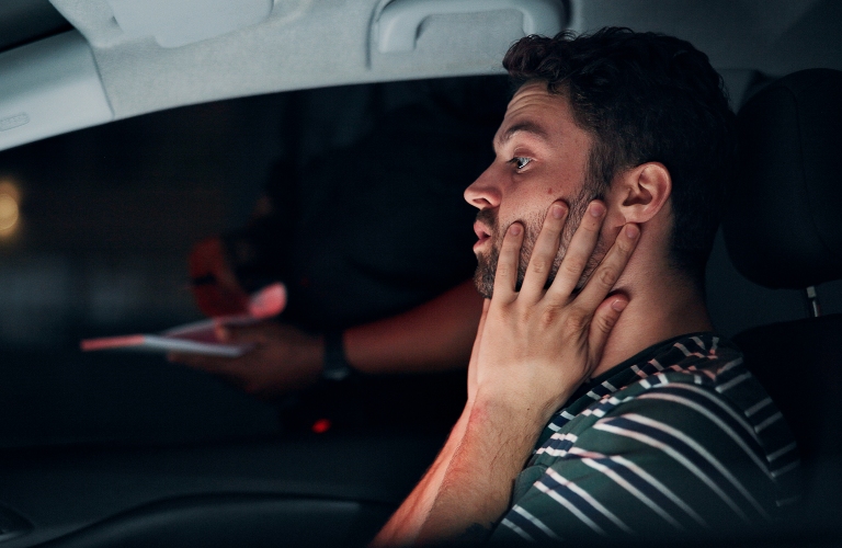 man and stress in car with police